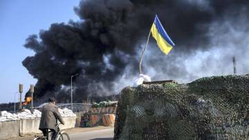 Black smoke rises from fuel storage of the Ukrainian army following a Russian attack, on the outskirts of Kyiv, Ukraine, Friday, March 25, 2022. 