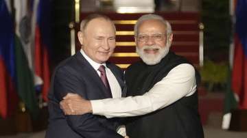 Russian President Vladimir Putin, left, and Prime Minister Narendra Modi greet each other before their meeting in New Delhi