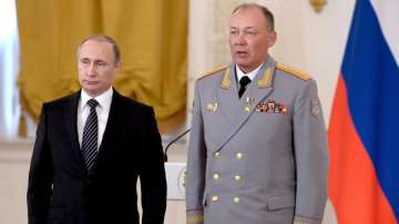 Russian President Vladimir Putin, left, poses with Col. Gen. Alexander Dvornikov during an awarding ceremony in Moscow's Kremlin, Russia. This photo taken on March 17, 2016.  