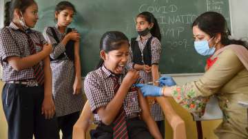 A healthcare worker administers a dose of the Covid-19 preventive vaccine to a student in Gurugram.