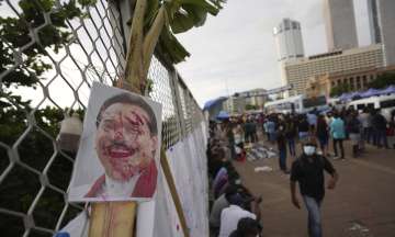 A disfigured portrait of Prime Minister Mahinda Rajapaksa is seen at a protest site outside the president's office in Colombo
 