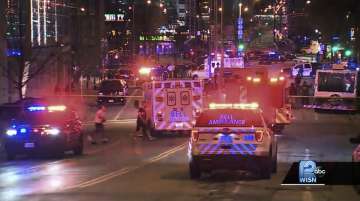 This photo taken from video provided by WISN 12 News shows police responding to the scene of a shooting at Water Street and Juneau Avenue in Milwaukee