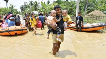State Disaster Response Fund (SDRF) personnel rescue people from a flood-affected village in Hojai district of Assam.