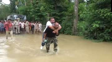 A flood-relief worker carries BJP MLA from Assam on his back.?