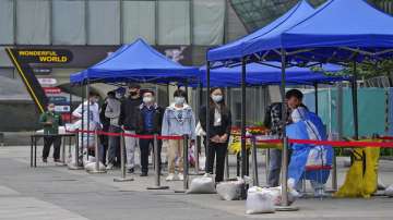 People get swabbed during a public COVID-19 testing at a site near a residential complex in the Chaoyang district.?