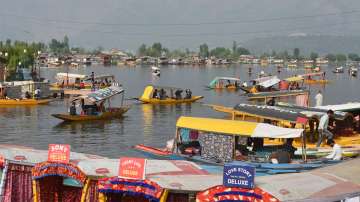 Tourists ride shikaras at Dal Lake in Srinagar, Monday, April 11, 2022. 