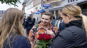 Denmark's Prime Minister Mette Frederiksen, centre, speaks to people while on an election campaign in Holbaek, Denmark on Saturday. 