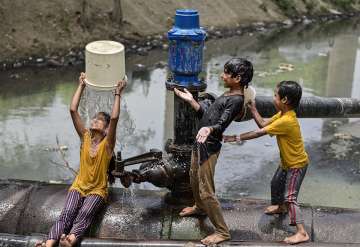 New Delhi: Children play with water to beat the heat on a hot summer afternoon, in New Delhi