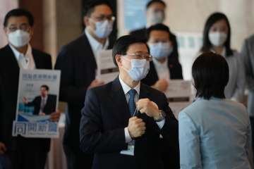 John Lee, former No. 2 official in Hong Kong, and the only candidate for the city’s top job speaks to election committee members outside a polling station for the chief executive election in Hong Kong, Sunday, May 8, 2022 