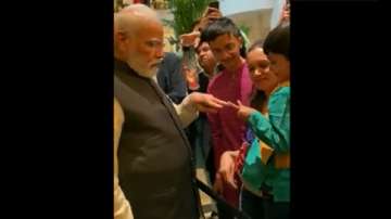 PM Modi shares a light moment with a child in Berlin, Germany.