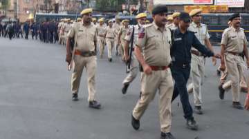 Police personnel conduct a route march during a curfew, in Jodhpur, Saturday, May 7, 2022.