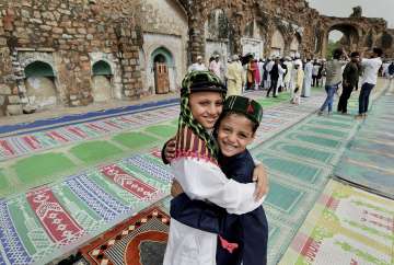 New Delhi: Muslim children greet each other after Eid prayers at Feroz Shah Kotla masjid, in New Delhi, Tuesday, May 3, 2022. Archaeological Survey of India (ASI) has taken the decision to buy tickets mandatory for those who come to offer prayers. 