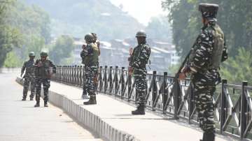 Security personnel stand guard during an encounter with terrorists in Srinagar, Sunday, April 10, 2022.