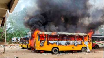 Smoke billows from buses after they were set on fire by people protesting against Centre's Agnipath scheme in Aurangabad on Friday, June 17