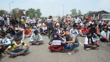 Youngsters stage a protest against the newly announced Agnipath scheme, at Jalandhar-Delhi national highway, in Jalandhar, Saturday, June 18, 2022.
