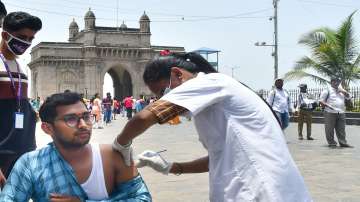 A healthcare worker administers a dose of Covid-19 vaccine to a beneficiary at Gateway of India in Mumbai on May 31.?