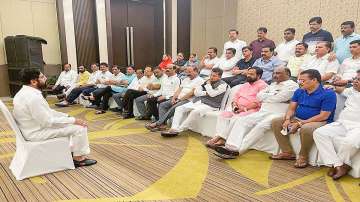 Rebel Shiv Sena leader Eknath Shinde interacts with supporting MLAs at a hotel in Guwahati, Thursday, June 23, 2022.