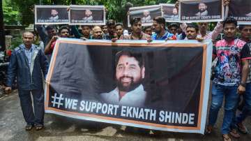 Supporters of Shiv Sena leader Eknath Shinde outside his residence, in Thane, Wednesday, June 22, 2022.