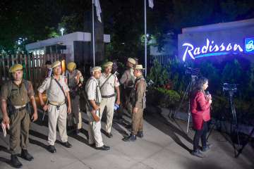 Security personnel stand guard outside the Radisson Blu Hotel, where Maharashtra's MPs and MLAs are staying, in Guwahati, Wednesday, June 22, 2022.