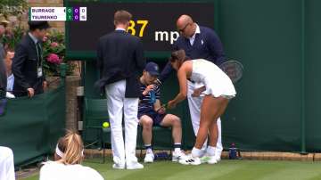 Burrage helping out the ball boy on the sidelines during her match 