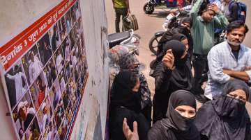 A woman objects after her son's name was included in the list of those accused to be involved in the June 3 violence in Kanpur.