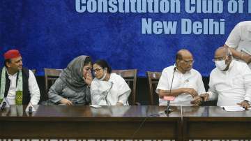 West Bengal Chief Minister and TMC Chief Mamata Banerjee interacts with PDP Chief Mehbooba Mufti during a press conference after the opposition leaders' meeting regarding upcoming Presidential elections, in New Delhi, Wednesday, June 15, 2022.