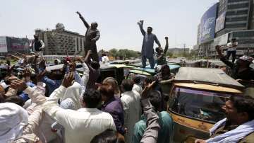 Pakistani rickshaw drivers chant slogans during a protest against the recent increasing in petrol prices. Pakistani government massively increased in petrol to revive IMF program draws.