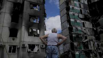 A man stands looking at a building destroyed during attacks, in Borodyanka, on the outskirts of Kyiv, Ukraine. 
