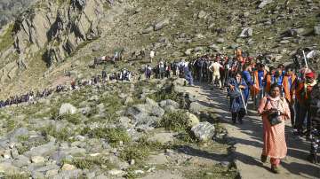 Pilgrims proceed for the cave shrine of Amarnath at an altitude of 3880mts, at Chandanwari in Anantnag district of south Kashmir, Thursday, June 30, 2022. 