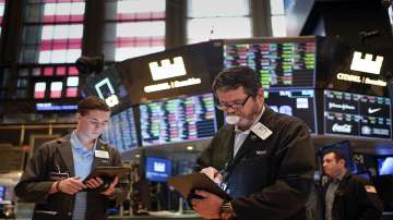 Traders work on the floor at the New York Stock Exchange in New York