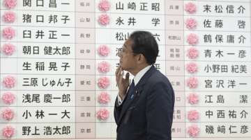 Fumio Kishida, Japan's prime minister and president of the Liberal Democratic Party (LDP), reacts after placing a red paper rose on an LDP candidate's name, to indicate a victory in the upper house election, at the party's headquarters in Tokyo, Japan,
