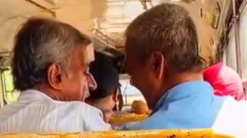 two men arguing over space on bus seat