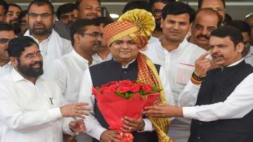 Newly-elected Maharashtra Assembly Speaker Rahul Narvekar being presented a bouquet by Maharashtra CM Eknath Shinde and Deputy CM Devendra Fadnavis after the special session of Maharashtra Assembly, at Vidhan Bhavan in Mumbai.