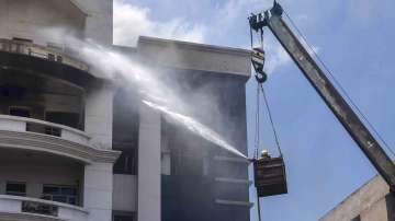 Firefighters try to douse a fire that broke out at Advocate General Office in Ambedkar Bhawan, in Prayagraj, Sunday, July 17, 2022. 