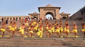 
Children perform yoga asanas, ahead of International Yoga Day on June 21, outside the Gateway of Kashi Vishwanath corridor, at Lalita Ghat in Varanasi, Sunday, June 12, 2022. 
