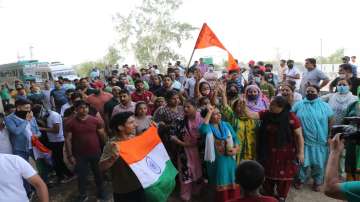 Kashmiri Pandits block the Jammu-Akhnoor National Highway during a protest over the killing of Rahul Bhat, in Jammu, Saturday, May 21, 2022.