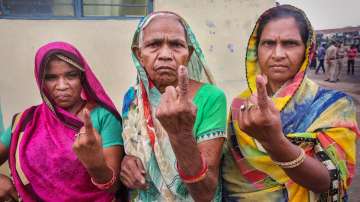 Women show their fingers marked with indelible ink after casting their votes for the second and last phase of Madhya Pradesh local bodies elections.