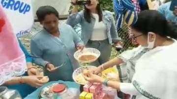 West Bengal Chief Minister Mamata Banerjee serves panipuri to people at a stall, during her visit to Darjeeling.