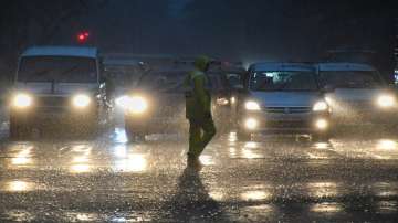 Vehicles ply on a road amid monsoon rains, in Mumbai, Monday, July 4, 2022.