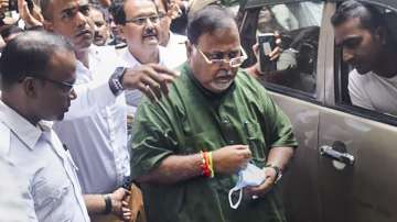 West Bengal Minister Partha Chatterjee being produced at a court after he was arrested by Enforcement Directorate (ED) officials in connection with its investigation into the teacher recruitment scam, in Kolkata.