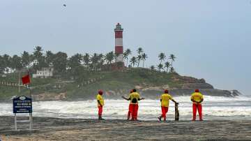 Lifeguards stand near the shore at a beach in Kovalam, in Thiruvananthapuram. 
