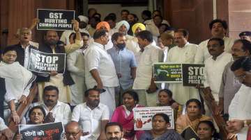 Congress MPs Rahul Gandhi, Digvijay Singh, Shaktisinh Gohil and others stage a protest over price hike, increase in GST on essential commodities and summoning of party president Sonia Gandhi by ED in the National Herald case, during ongoing Monsoon Session of Parliament, in New Delhi.