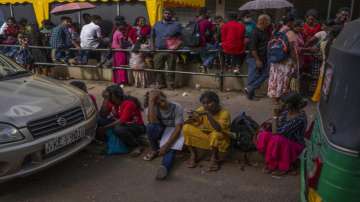 People wait in queue to get their passports outside Department of Immigration & Emigration in Colombo, Sri Lanka, Monday, July 18, 2022.