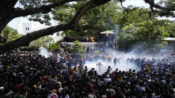 Police use tear gas as protesters storm the compound of Prime Minister Ranil Wickremesinghe 's office, demanding his resignation after president Gotabaya Rajapaksa fled the country amid economic crisis in Colombo, Sri Lanka on Wednesday, July 13