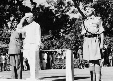 FILE - Jawaharlal Nehru salutes the flag as he becomes independent India's first prime minister on Aug. 15, 1947 during the Independence Day ceremony at Red Fort, New Delhi.