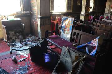 Burned furniture, including wooden tables and chairs, are seen at the site of a fire inside the Abu Sefein Coptic church in the densely populated neighborhood of Imbaba, Cairo Egypt. 