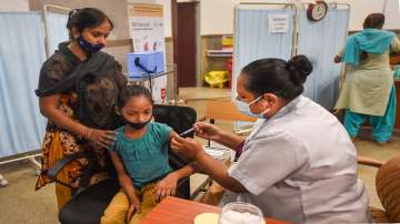 A medic administers the Covid-19 vaccine dose to a beneficiary at the Lady Hardinge Hospital, in New Delhi.