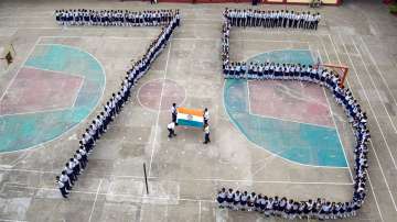 Students make a human chain in a formation that reads 75 as they celebrate Azadi Ka Amrit Mahotsav’ ahead of Independence Day, at a school in Prayagraj. 