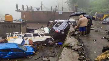 Vehicles were damaged after being hit by flash flood, following heavy monsoon rains in Mandi on Saturday.