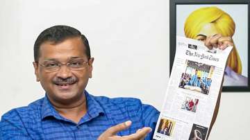 Delhi CM Arvind Kejriwal shows report about Delhis education system from The New York Times, in New Delhi.